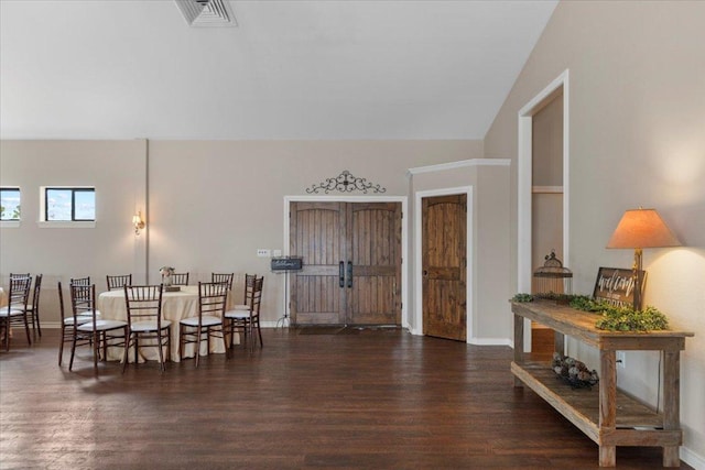interior space with baseboards, wood finished floors, and visible vents