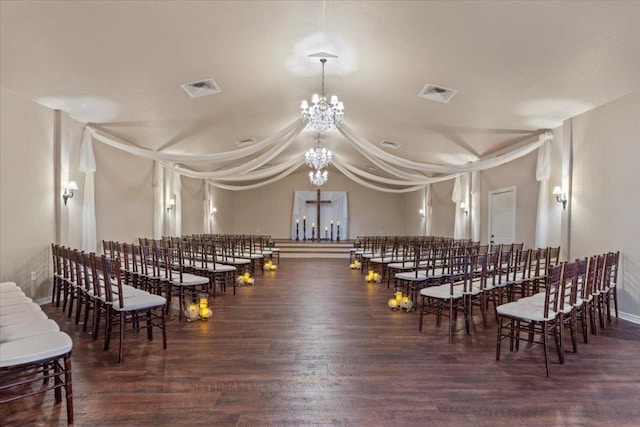 dining area with an inviting chandelier, wood finished floors, and visible vents