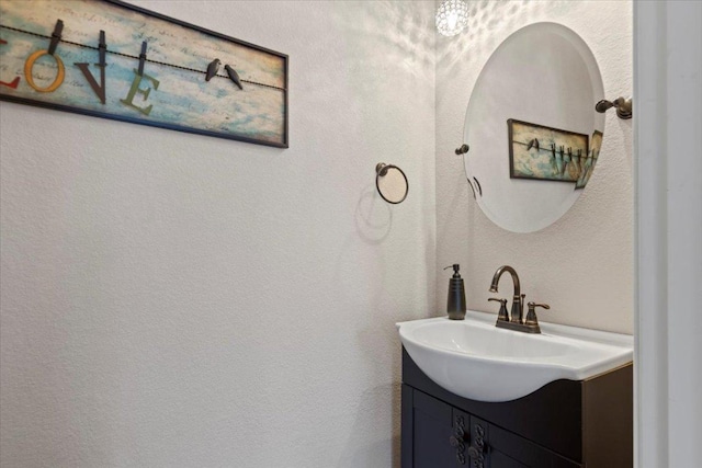 bathroom with vanity and a textured wall
