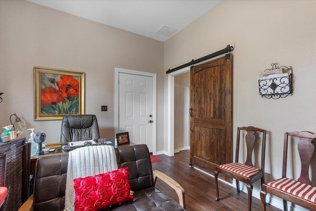 sitting room featuring baseboards, a barn door, wood finished floors, and visible vents