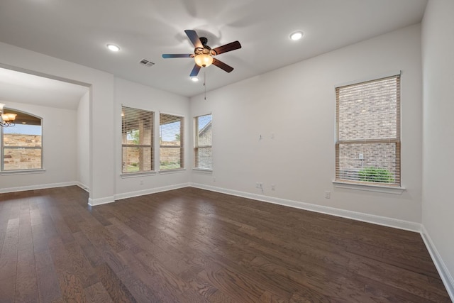 unfurnished room with visible vents, baseboards, ceiling fan with notable chandelier, dark wood-style floors, and recessed lighting