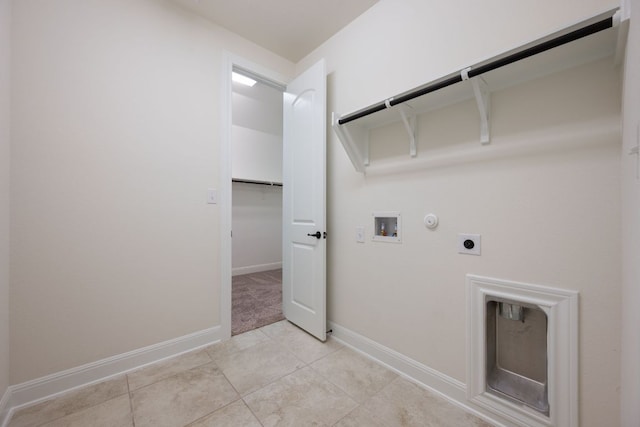 clothes washing area featuring laundry area, hookup for a gas dryer, baseboards, washer hookup, and hookup for an electric dryer