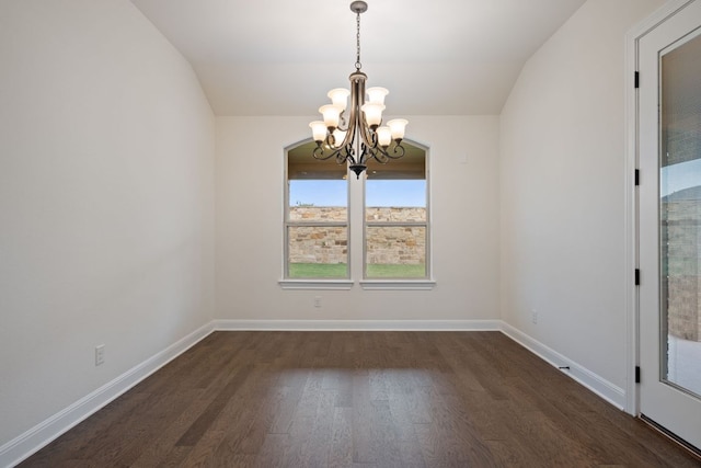 unfurnished dining area featuring an inviting chandelier, baseboards, lofted ceiling, and wood finished floors