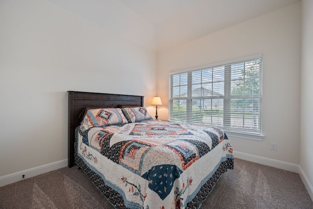 carpeted bedroom featuring baseboards