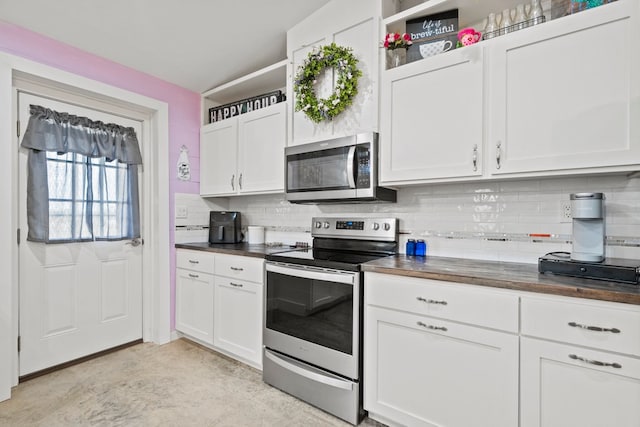 kitchen with appliances with stainless steel finishes and white cabinets