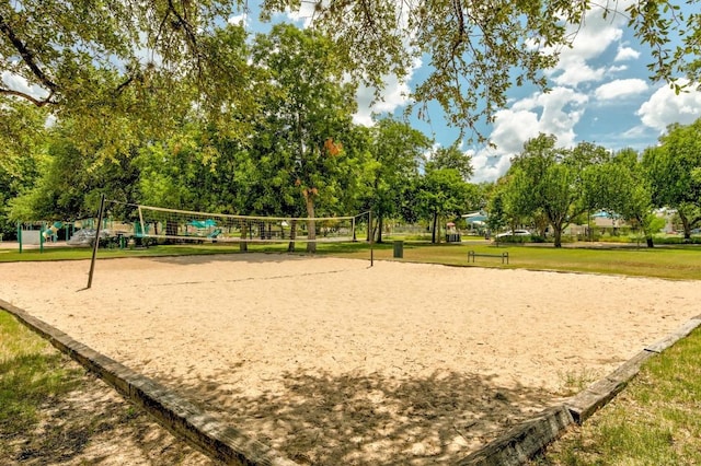 view of property's community featuring a lawn and volleyball court
