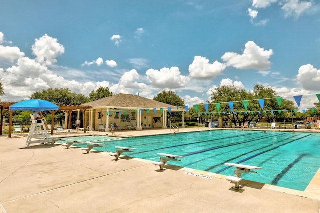 pool featuring a patio and a diving board