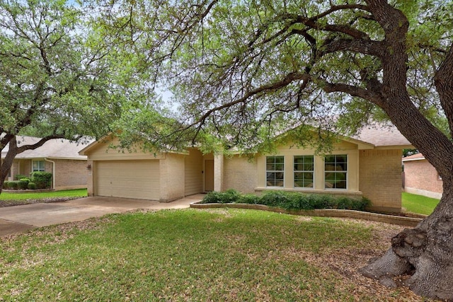 ranch-style home featuring brick siding, an attached garage, driveway, and a front yard