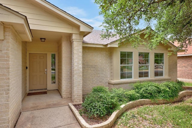 property entrance with brick siding