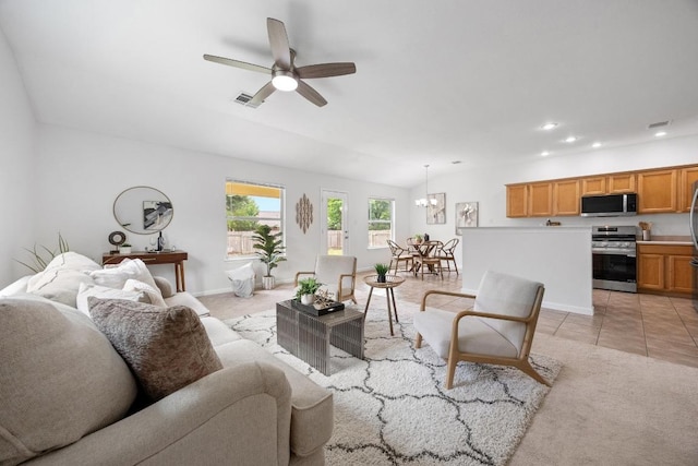 living area with ceiling fan with notable chandelier, recessed lighting, light colored carpet, and visible vents