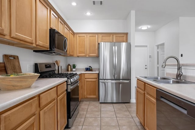 kitchen featuring visible vents, light tile patterned flooring, light countertops, a sink, and stainless steel appliances