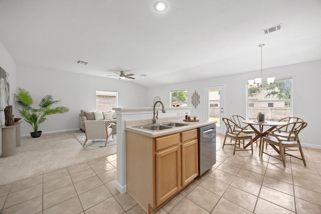 kitchen featuring plenty of natural light, visible vents, stainless steel dishwasher, a sink, and light tile patterned floors