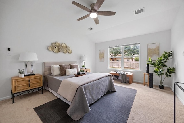bedroom featuring vaulted ceiling, light colored carpet, and visible vents