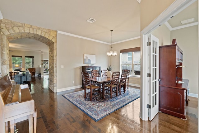 13358 Mesa Verde Dr, Austin, TX 78737 - dining area with a chandelier, arched walkways, dark wood finished floors, and crown molding