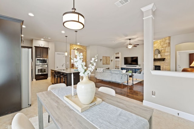 dining area with a fireplace, a ceiling fan, baseboards, recessed lighting, and visible vents