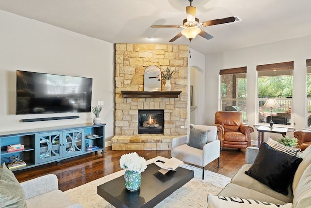 13358 Mesa Verde Dr, Austin, TX 78737 - living room featuring wood finished floors, a fireplace, ceiling fan, and arched walkways