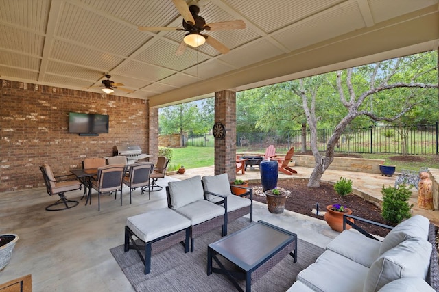 13358 Mesa Verde Dr, Austin, TX 78737 - fenced backyard with an outdoor living space with a fire pit, outdoor dining area, a ceiling fan, and a patio area