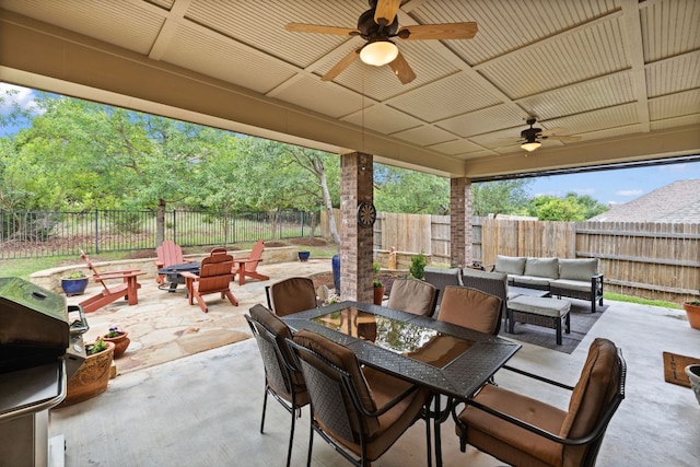view of patio with outdoor dining area, a fenced backyard, ceiling fan, and a grill
