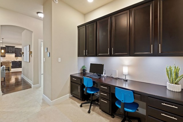 13358 Mesa Verde Dr, Austin, TX 78737 - home office with built in study area, arched walkways, and light tile patterned floors