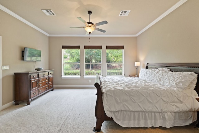 carpeted bedroom with crown molding, baseboards, and visible vents