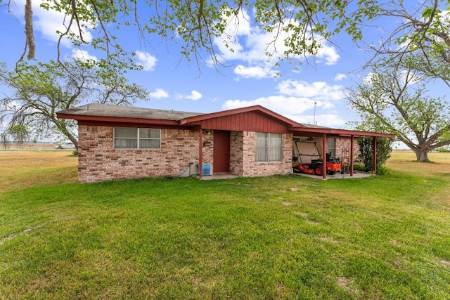 view of front of property with central AC unit, a front yard, and brick siding