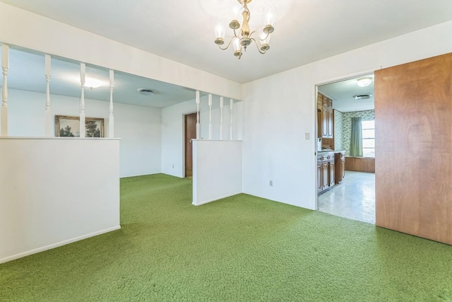 empty room with carpet flooring and a chandelier