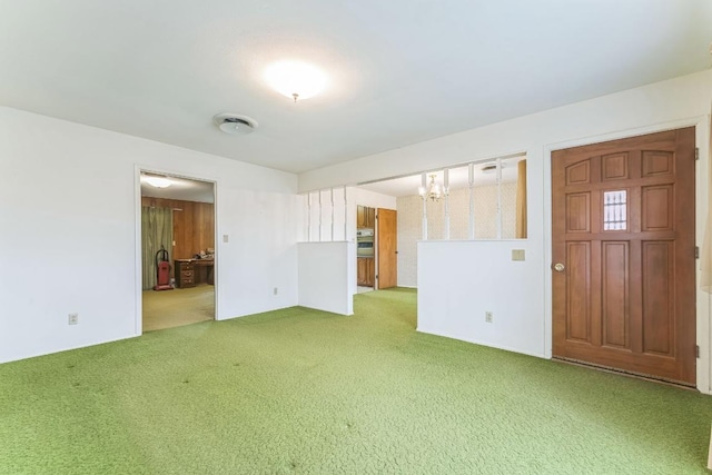 unfurnished living room featuring carpet floors and a chandelier