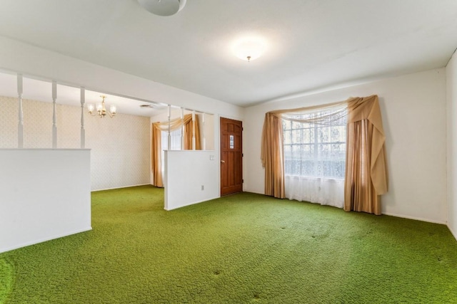 unfurnished room featuring carpet floors and a chandelier
