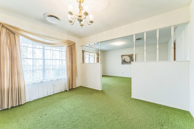 carpeted empty room with a notable chandelier