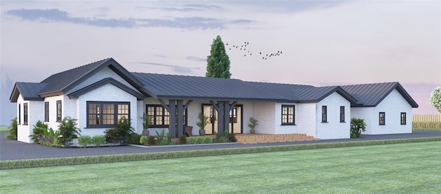 413 E Flying Owl Dr, Johnson City, TX 78636 - modern inspired farmhouse featuring brick siding, a front lawn, and a metal roof