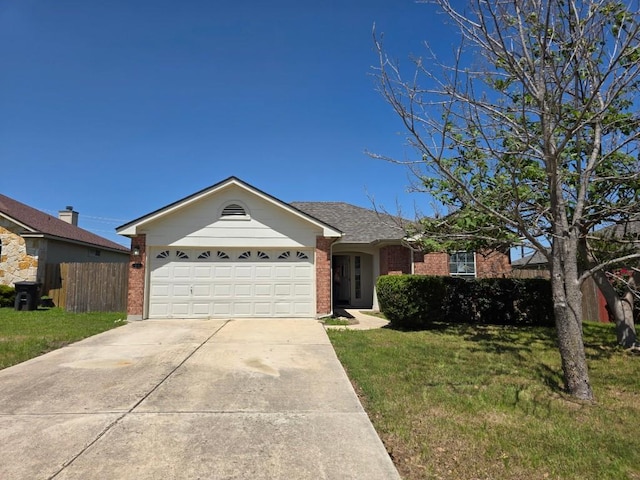 684 Atlantis, Kyle, TX 78640 - single story home featuring brick siding, a garage, a front lawn, and concrete driveway