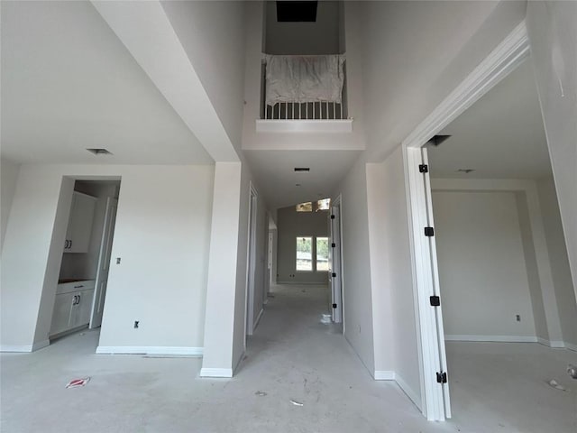 hall featuring visible vents and baseboards