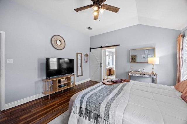 bedroom with a barn door, baseboards, wood finished floors, vaulted ceiling, and visible vents