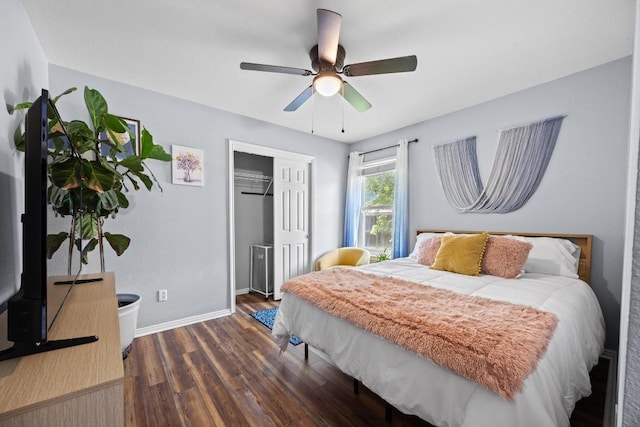 bedroom featuring baseboards, ceiling fan, a closet, and dark wood finished floors