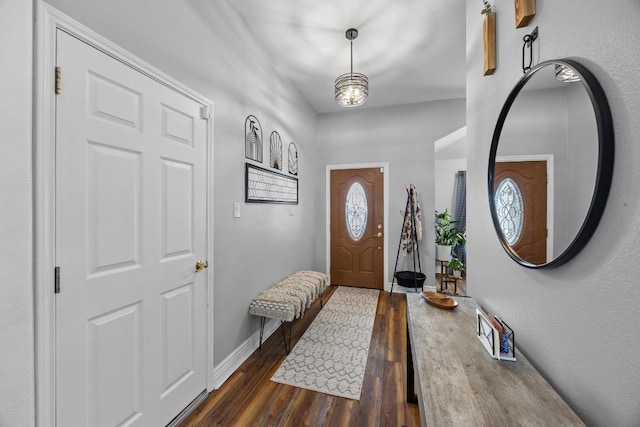 entrance foyer with baseboards and dark wood-style floors