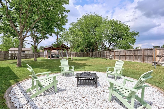 view of yard with a gazebo, a fenced backyard, and an outdoor fire pit