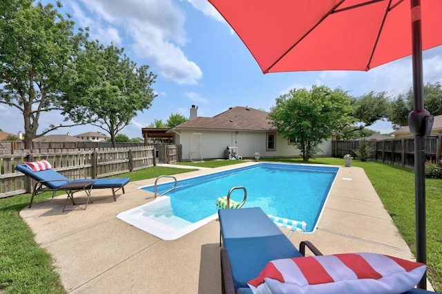 view of swimming pool featuring a fenced backyard, a fenced in pool, a yard, and a patio area