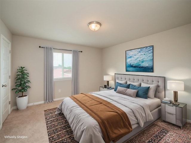 bedroom with baseboards and light colored carpet