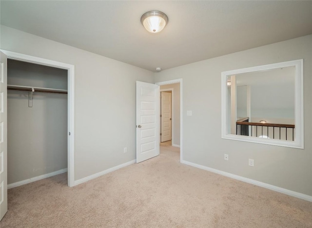 unfurnished bedroom with baseboards, carpet, and a closet
