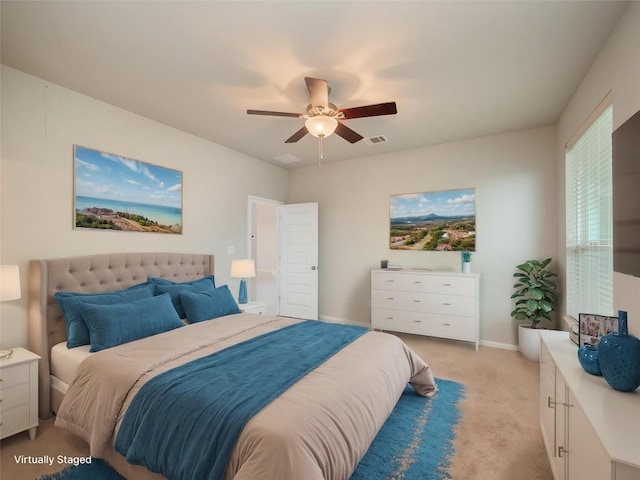 bedroom with light colored carpet, a ceiling fan, baseboards, and visible vents