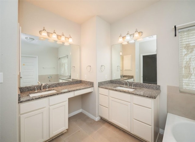 full bathroom featuring two vanities, a sink, and a tub to relax in