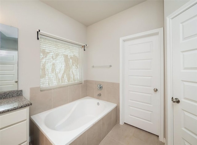 800 Savannah Cv, Elgin, TX 78621 - full bathroom featuring a garden tub, vanity, and tile patterned floors