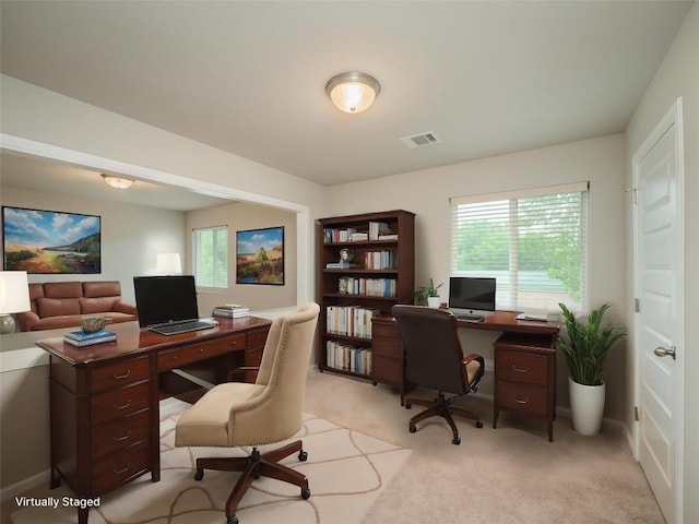 office featuring light carpet and visible vents