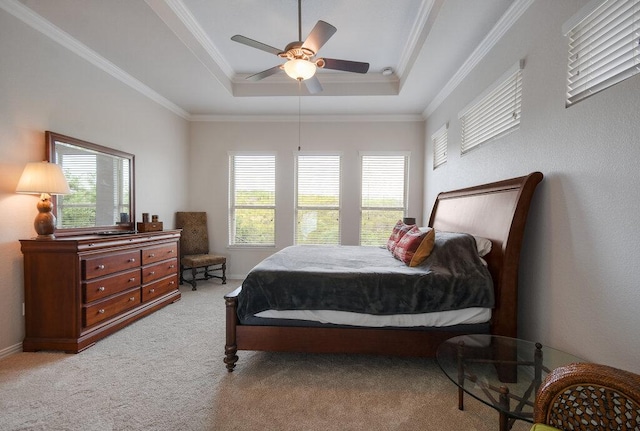 bedroom with crown molding, a raised ceiling, light carpet, and multiple windows