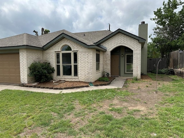 ranch-style home with a garage, fence, a chimney, brick siding, and a shingled roof