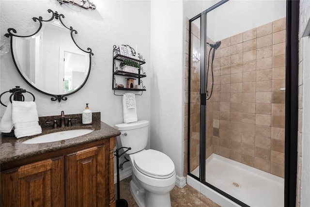 full bathroom with vanity, baseboards, toilet, and a shower stall