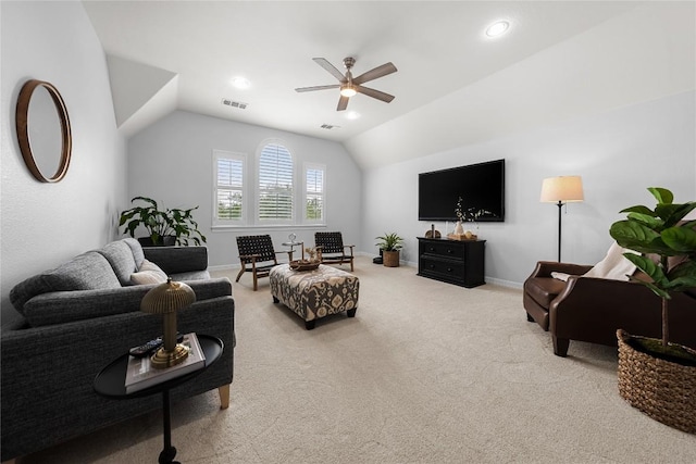 living room with ceiling fan, light colored carpet, baseboards, vaulted ceiling, and visible vents