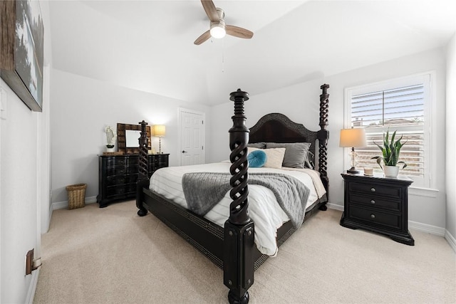bedroom with light colored carpet, a ceiling fan, baseboards, and lofted ceiling