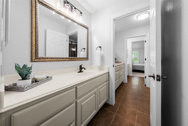 ensuite bathroom featuring tile patterned floors, vanity, and connected bathroom