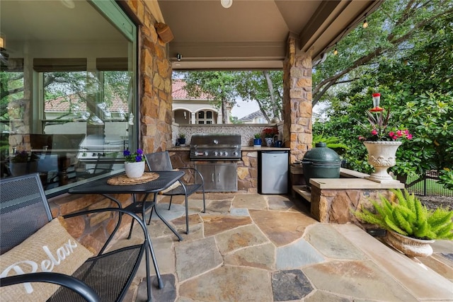 view of patio featuring fence, grilling area, and area for grilling